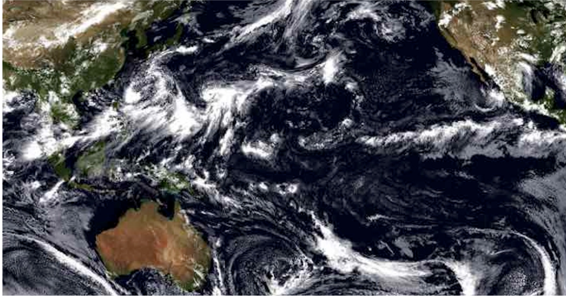A satellite image of earth with swirly white clouds